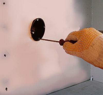 Przy pomocy śrubokręta zakręca się zewnętrzne śrubki skrzynki